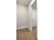 Neutral hallway showing access to rooms, wood-look tile flooring, and white trim at 2792 Se 29Th St, Ocala, FL 34471