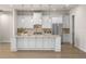 Kitchen island with marble countertop, stainless steel appliances and shaker style cabinets at 2792 Se 29Th St, Ocala, FL 34471