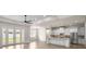 Open living space with island kitchen, stainless appliances, and outdoor access at 2792 Se 29Th St, Ocala, FL 34471