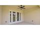 Outdoor patio with ceiling fan and view of fenced backyard through glass doors at 2792 Se 29Th St, Ocala, FL 34471