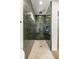 Stylish shower adorned with green tile, a rain shower head, and a mosaic tile floor at 2792 Se 29Th St, Ocala, FL 34471