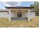 Covered patio offers a seamless indoor-outdoor transition, ideal for enjoying the peaceful backyard setting at 28 Water Track Dr, Ocala, FL 34472
