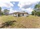Large backyard featuring a covered patio; ideal for enjoying peaceful outdoor moments and gatherings at 28 Water Track Dr, Ocala, FL 34472