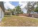Expansive backyard with plenty of space for outdoor activities, including a covered back porch at 28 Water Track Dr, Ocala, FL 34472