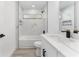 Bright bathroom featuring marble tile, modern vanity, and shower-tub combo at 28 Water Track Dr, Ocala, FL 34472