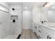 Modern bathroom featuring a marble tiled walk-in shower and a double sink vanity with black hardware at 28 Water Track Dr, Ocala, FL 34472