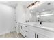 Modern bathroom featuring double sink vanity and a walk in shower with marble tile at 28 Water Track Dr, Ocala, FL 34472