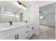 Bright bathroom featuring double sink vanity and a view of the shower and bedroom at 28 Water Track Dr, Ocala, FL 34472