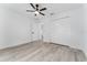 Bright bedroom with wood-look floors, white walls, and a ceiling fan at 28 Water Track Dr, Ocala, FL 34472