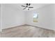Cozy bedroom with wood-look floors and a window view of the outdoors at 28 Water Track Dr, Ocala, FL 34472