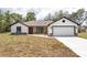 Charming single-story home featuring stone accents, a two-car garage, fresh grass, and a welcoming front door at 28 Water Track Dr, Ocala, FL 34472
