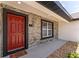 Close-up of the front door with decorative textured stone walls and a colorful welcome mat at 28 Water Track Dr, Ocala, FL 34472