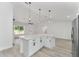 Spacious kitchen featuring white cabinetry, modern lighting, and stainless appliances at 28 Water Track Dr, Ocala, FL 34472