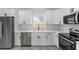 Close up of updated kitchen with stainless steel appliances and white cabinetry at 28 Water Track Dr, Ocala, FL 34472