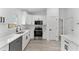 Updated kitchen showcases white cabinets and stainless steel appliances for appeal at 28 Water Track Dr, Ocala, FL 34472