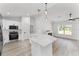 Modern kitchen with island, stainless steel appliances, and bright white cabinetry at 28 Water Track Dr, Ocala, FL 34472