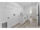 Well-lit laundry room boasts ample storage, modern fixtures, and convenient access to other areas of the home at 28 Water Track Dr, Ocala, FL 34472