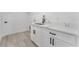 Stylish laundry area with white cabinetry and modern fixtures at 28 Water Track Dr, Ocala, FL 34472
