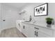 Bright laundry room features a modern washer and dryer, stylish cabinets, and sleek countertops at 28 Water Track Dr, Ocala, FL 34472
