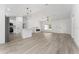 Bright open layout features a modern kitchen with stainless steel appliances, an electric fireplace, and recessed lighting at 28 Water Track Dr, Ocala, FL 34472