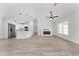 Spacious living room with a modern kitchen featuring stainless steel appliances and a cozy electric fireplace at 28 Water Track Dr, Ocala, FL 34472