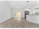 Open concept living room flows to the kitchen with stainless steel appliances and a sliding door to the backyard at 28 Water Track Dr, Ocala, FL 34472