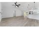 Open-concept living space featuring a modern kitchen with stainless steel appliances and a sliding glass door to the backyard at 28 Water Track Dr, Ocala, FL 34472