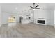 Open living space with modern kitchen featuring an island and an electric fireplace providing warmth and style at 28 Water Track Dr, Ocala, FL 34472