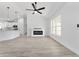 Open-concept living area showcasing an electric fireplace, a modern kitchen, and recessed lighting throughout at 28 Water Track Dr, Ocala, FL 34472