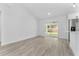 Open living space with sliding glass doors and light colored wood flooring at 28 Water Track Dr, Ocala, FL 34472