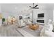 Stylishly furnished living and dining area, showcasing a modern kitchen and sleek electric fireplace for comfortable living at 28 Water Track Dr, Ocala, FL 34472