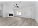 Bright living room featuring sleek fireplace, new floors, and white walls at 28 Water Track Dr, Ocala, FL 34472