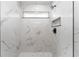 Sleek walk-in shower featuring marble tile and modern fixtures at 28 Water Track Dr, Ocala, FL 34472