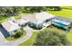 Aerial view showcasing a private pool with screened enclosure and manicured lawns at 3440 Sw 66Th St, Ocala, FL 34476