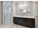 Bathroom with dark wood cabinets, light countertops, and a glass-enclosed shower at 3440 Sw 66Th St, Ocala, FL 34476