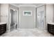Bathroom showcasing double vanities, a glass-enclosed shower, and travertine tile floors at 3440 Sw 66Th St, Ocala, FL 34476
