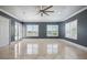 Light-filled bedroom featuring marble floors, crown molding, and bright windows with shutters at 3440 Sw 66Th St, Ocala, FL 34476