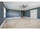 Spacious bedroom featuring light-filled marble floors, crown molding, and a modern ceiling fan at 3440 Sw 66Th St, Ocala, FL 34476