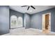 Bedroom featuring a ceiling fan, window seat, and ensuite bathroom at 3440 Sw 66Th St, Ocala, FL 34476