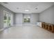 Large, airy bonus room featuring tile flooring, a sink, counter space, and natural light from windows and French doors at 3440 Sw 66Th St, Ocala, FL 34476