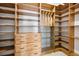 Spacious walk-in closet with custom wooden shelving, drawers, and wire baskets for organization at 3440 Sw 66Th St, Ocala, FL 34476