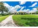 Beautiful sprawling estate with a tile roof, lush green lawn, and a long driveway leading to the grand entrance at 3440 Sw 66Th St, Ocala, FL 34476