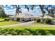 Expansive home showcasing meticulously landscaped grounds, beautiful architectural details, and lush green lawn at 3440 Sw 66Th St, Ocala, FL 34476