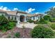 Beautiful home exterior with lush landscaping, stone accents, and a grand entrance with columns at 3440 Sw 66Th St, Ocala, FL 34476
