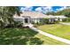 Expansive single-story estate home with a manicured lawn, lush landscaping, and a winding brick pathway to the entrance at 3440 Sw 66Th St, Ocala, FL 34476
