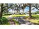 Stunning single-story home featuring a circular driveway and mature trees providing ample shade and curb appeal at 3440 Sw 66Th St, Ocala, FL 34476