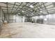 Spacious metal building interior with high ceilings, industrial lighting, and a large roll-up door for easy access at 3440 Sw 66Th St, Ocala, FL 34476
