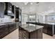 Well-equipped kitchen with dark wood cabinets, marble countertops, stainless steel appliances, and open access to the living areas at 3440 Sw 66Th St, Ocala, FL 34476