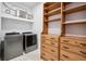 Laundry room with stainless steel washer and dryer plus wood shelving with drawers at 3440 Sw 66Th St, Ocala, FL 34476