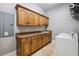 Bright laundry room with ample cabinet space, marble countertops, and modern washer and dryer appliances at 3440 Sw 66Th St, Ocala, FL 34476